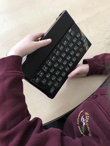 Photo of child holding a zx spectrum computer